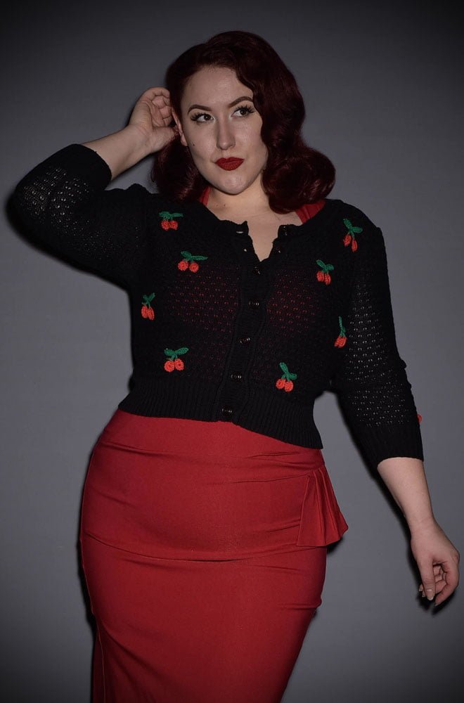 This 50's inspired Black Cherry Cardigan is a fabulous wardrobe essential. Featuring a round neck, 3/4 length sleeves & buttons through the front.