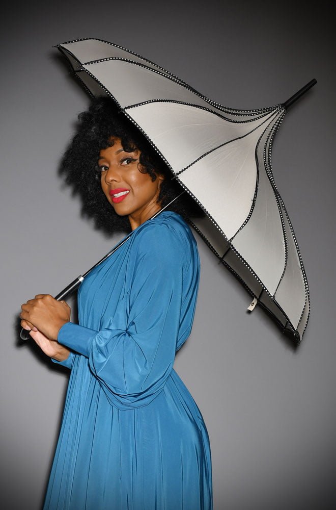 This full-size Ivory Polka Dot Trimmed Pagoda Umbrella is striking and practical. A rainy day has never been so much fun! 