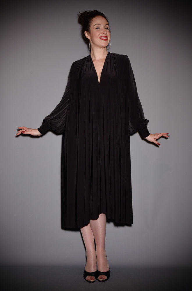 The Black Claudia Dress is a draped jersey dress with sash waist & bishop sleeves. A signature piece by Alexandra King for Deadly is the Female.