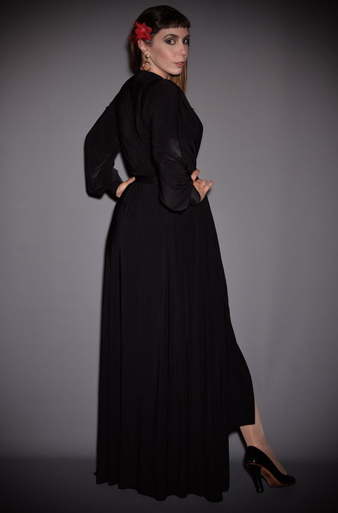 The Black Claudia Gown is a draped jersey evening dress with sash waist & bishop sleeves. A signature piece by Alexandra King for Deadly is the Female.