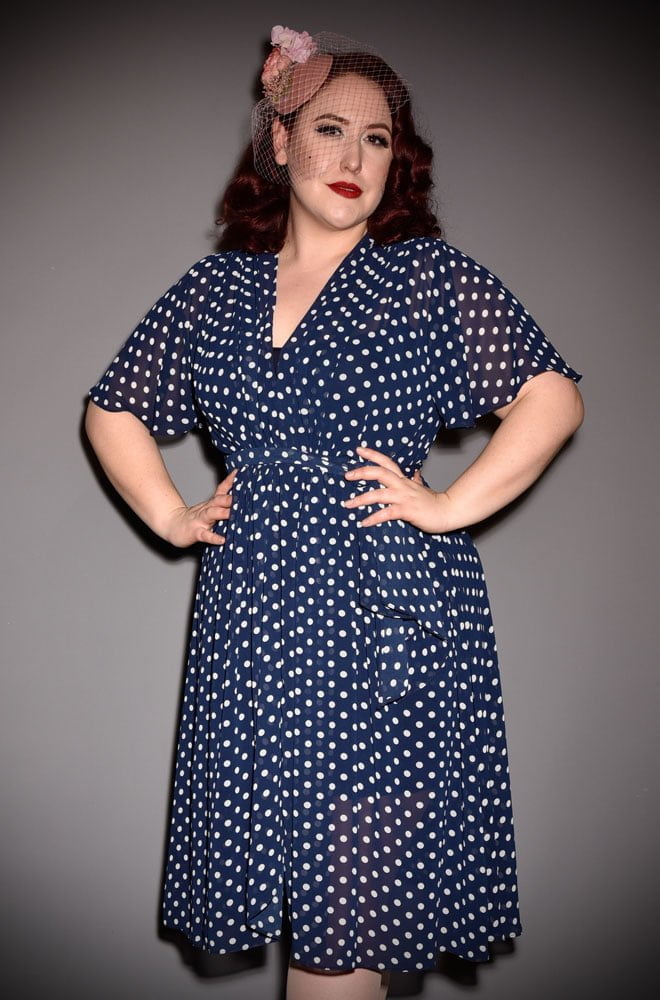 The Navy Polka Dot Flutter Sleeve Claudia Dressis a draped georgette dress with sash waist. A signature piece by Alexandra King for Deadly is the Female.