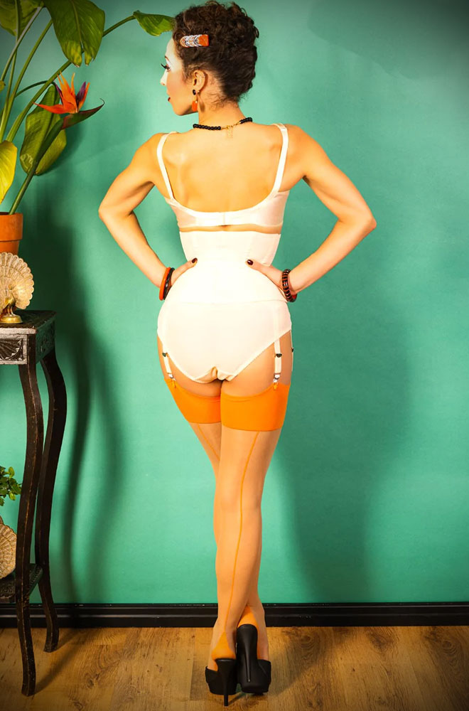 The Pumpkin Glamour Seamed Stockings are sheer champagne nylons with a pumpkin spiced orange seam. They add a little bit of glamour to any outfit.