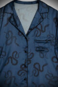 Long sleeve, button-up shirt & wide leg trouser style blue Satin Snake Pyjama Set. Featuring black snakes dancing across a soft, rich blue satin.