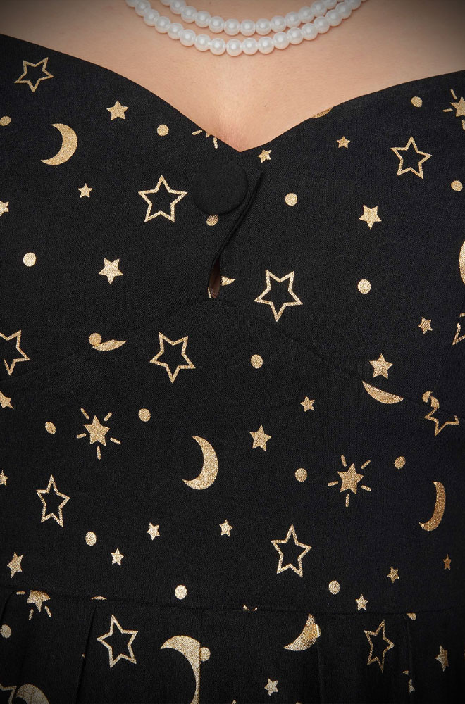 The Star Print Midge Dress is an effortlessly elegant 50s-style dress in black with a metallic gold celestial print. Perfect with a petticoat.