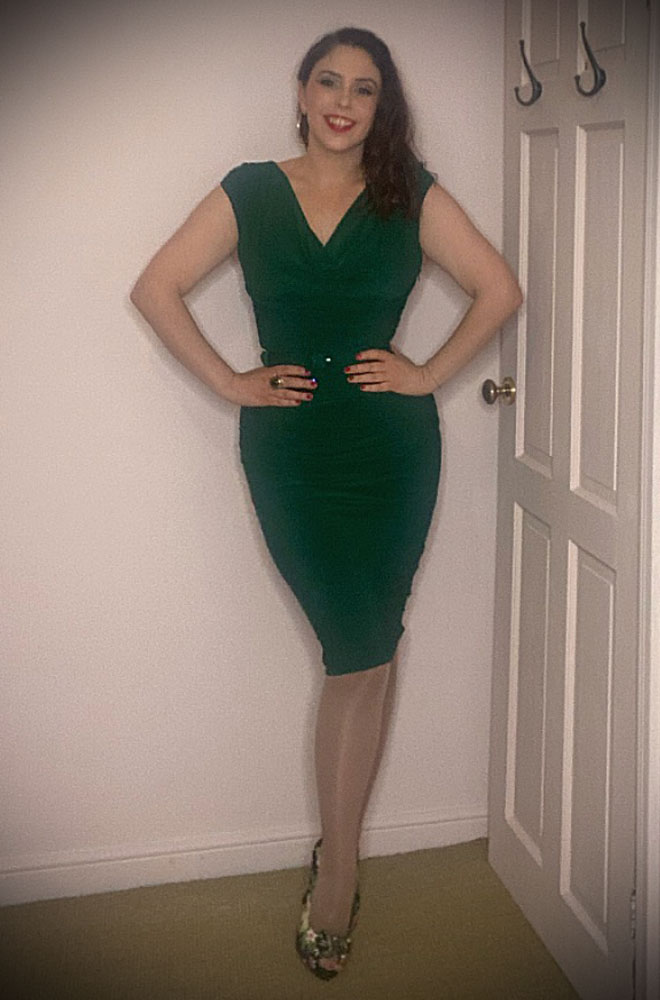 The Green Billie Wiggle Dress will flatter your curves & add instant glamour. Featuring a ruched, midi-length pencil skirt, cowl neckline, & cap sleeves.