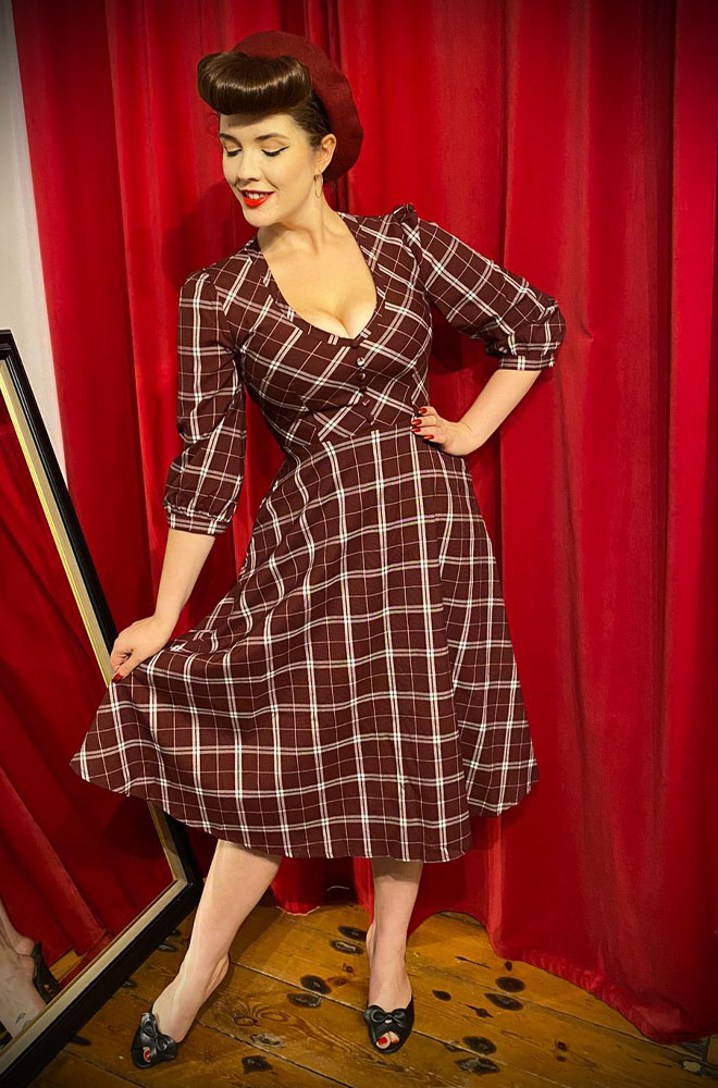 The Willow Swing Dress is a beautiful fit and flare dress, in wine check fabric. Pair with a fitted cardigan and boots in colder months.