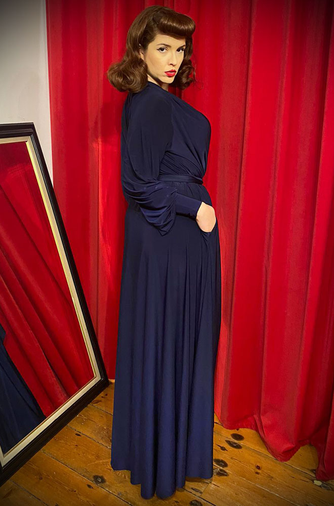 The Navy Claudia Gown is a draped jersey evening dress with bishop sleeves. A signature piece by Alexandra King for Deadly is the Female.