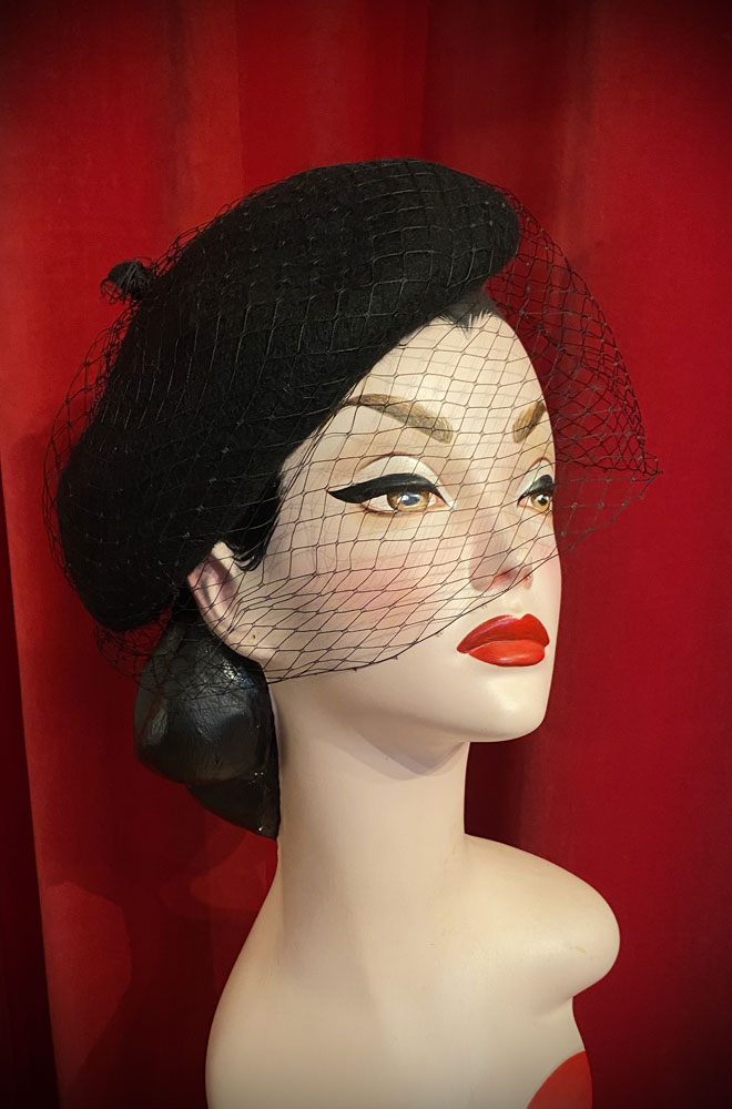 The Black Widow Veiled Beret is a wool-style beret with net detail. Perfect for femme fatales and pinup girls. Vintage style glamour with no effort!