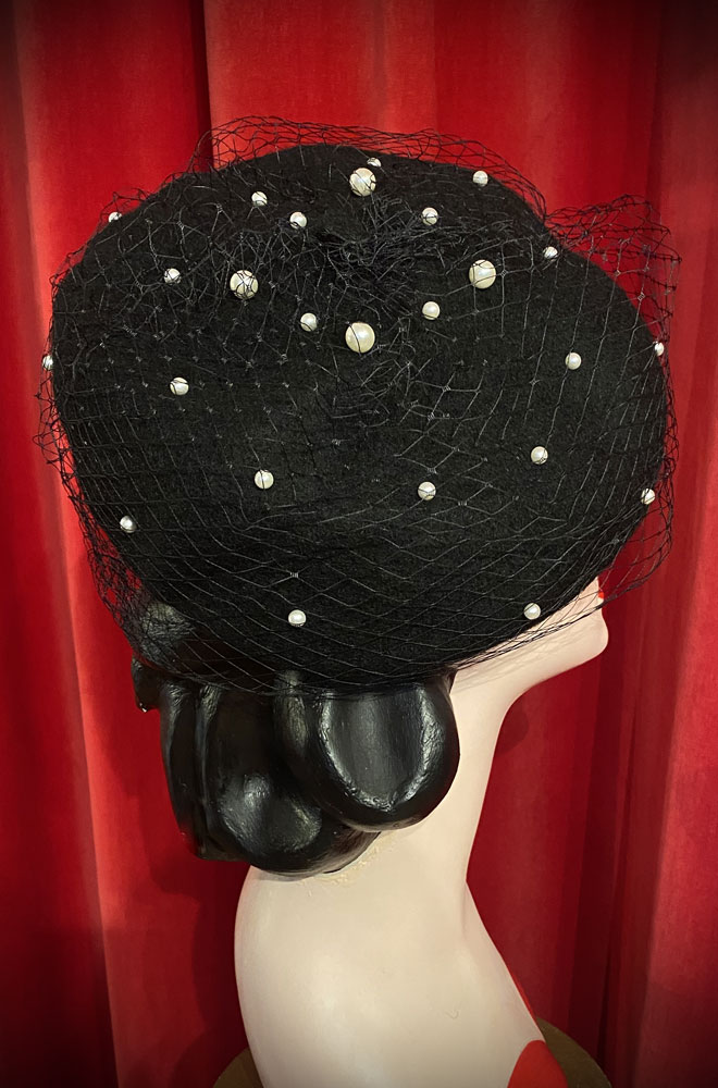 The Black Pearl Veiled Beret is a wool-style beret with net & pearl details. Perfect for femme fatales & pinup girls. Vintage style glamour with no effort!