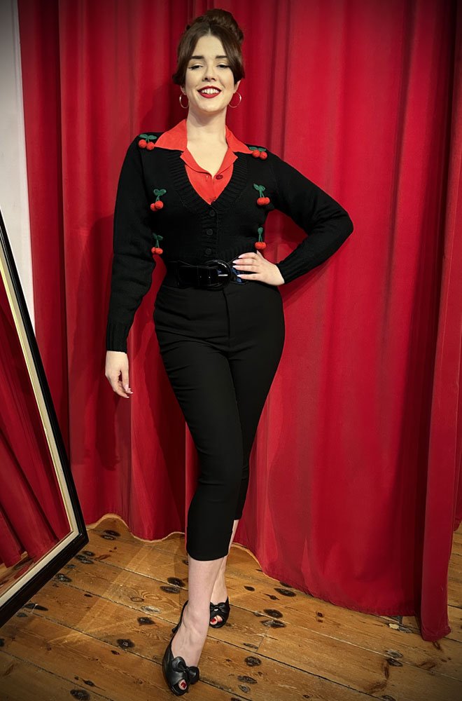 Cherry Pocket Capris are cut in a black stretch blend that hugs your curves, while the high waist is nipped in. UK stockists of Unique Vintage.