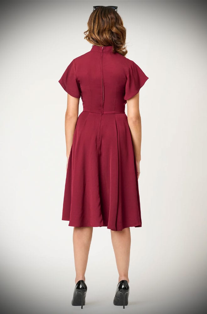 The Evil Eye Swing Dress is an elegant vintage-style dress in burgundy, featuring a stunning, mystic embroidery. A vintage-inspired dress for pinup girls.