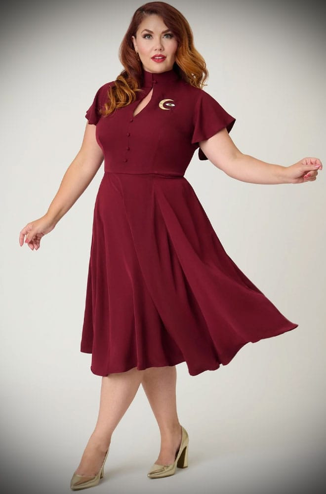 The Evil Eye Swing Dress is an elegant vintage-style dress in burgundy, featuring a stunning, mystic embroidery. A vintage-inspired dress for pinup girls.