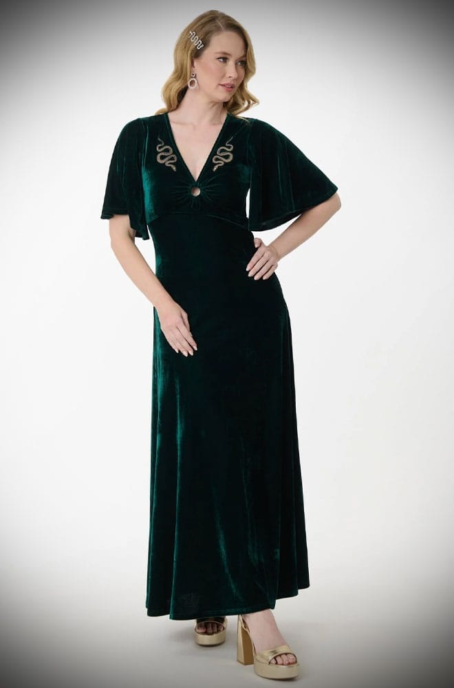 The Snake Maxi Dress is a bewitching 1970s-style maxi dress - crafted in emerald green velvet, with golden snakes & keyhole detail.
