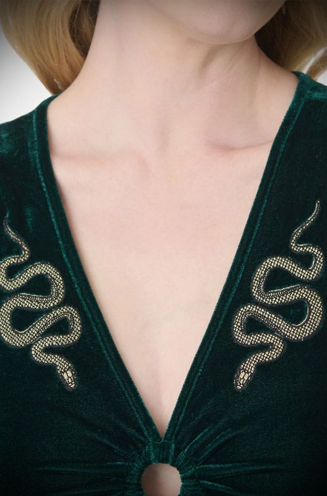 The Snake Maxi Dress is a bewitching 1970s-style maxi dress - crafted in emerald green velvet, with golden snakes & keyhole detail.