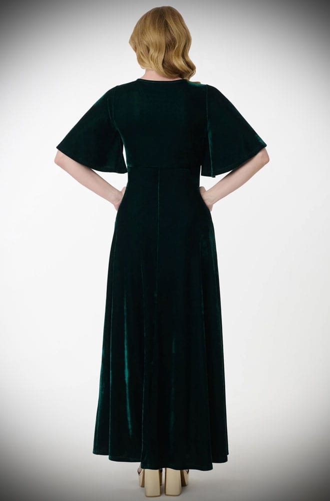 The Snake Maxi Dress is a bewitching 1970s-style maxi dress - crafted in emerald green velvet, with golden snakes & keyhole detail.