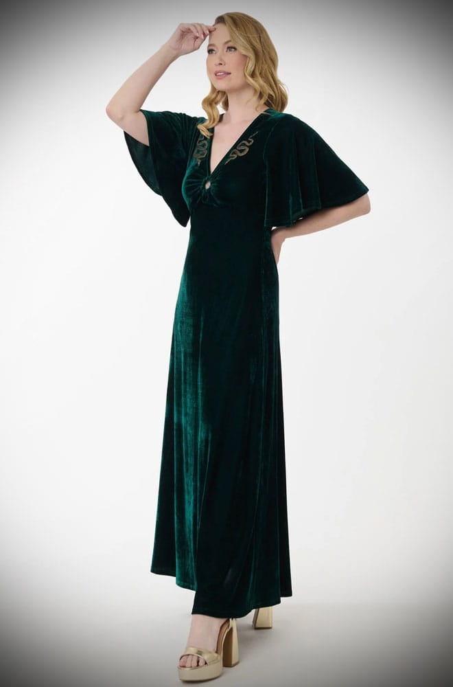 The Snake Maxi Dress is a bewitching 1970s-style maxi dress - crafted in emerald green velvet, with golden snakes & keyhole detail.