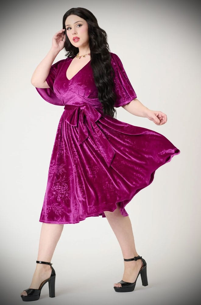 The Snake Velvet Swing Dress is a vintage-inspired dress in luxurious magenta velvet, with embossed snake details, with hidden pockets!