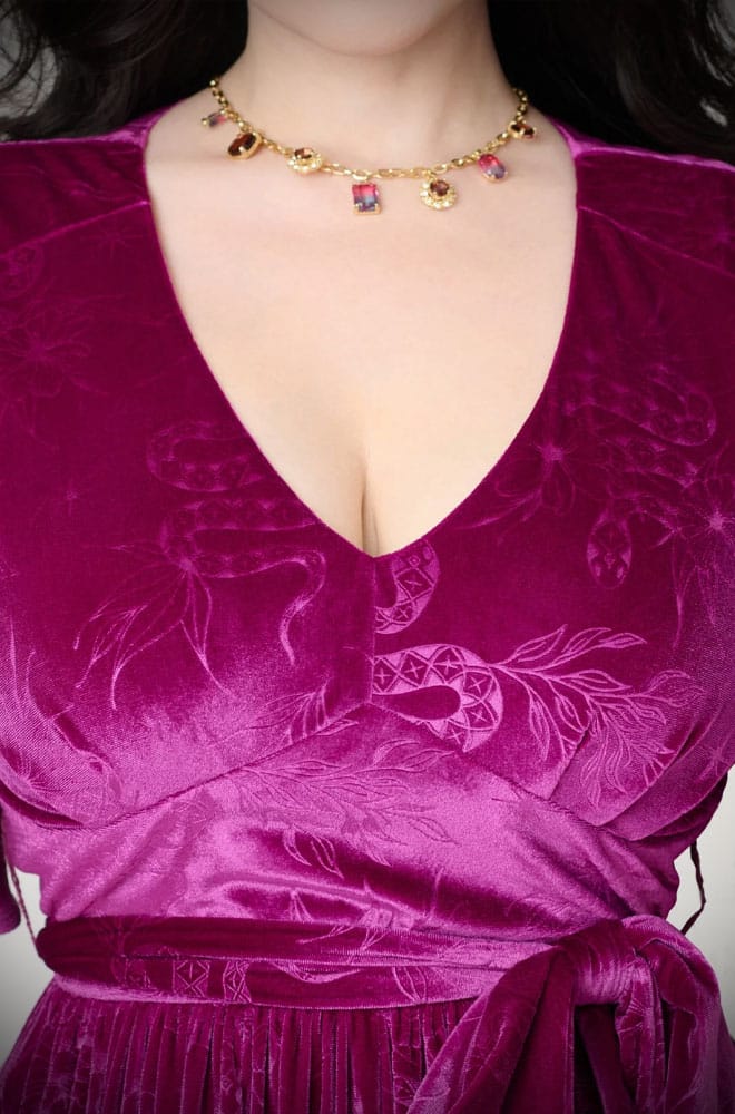 The Snake Velvet Swing Dress is a vintage-inspired dress in luxurious magenta velvet, with embossed snake details, with hidden pockets!