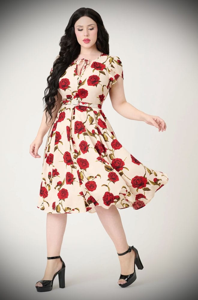 Red Rose Swing Dress is a vintage-inspired dress, covered in a romantic floral print. This 40s-style dress features a full skirt with pockets.