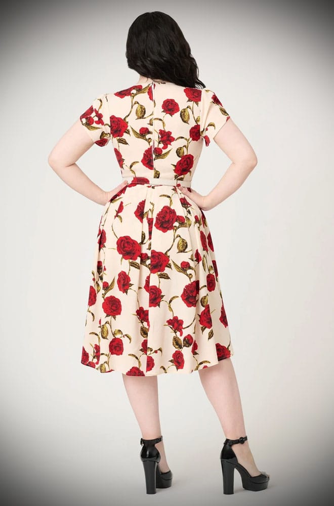 Red Rose Swing Dress is a vintage-inspired dress, covered in a romantic floral print. This 40s-style dress features a full skirt with pockets.