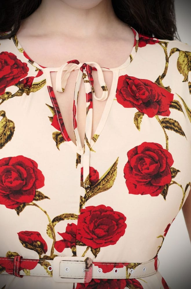 Red Rose Swing Dress is a vintage-inspired dress, covered in a romantic floral print. This 40s-style dress features a full skirt with pockets.
