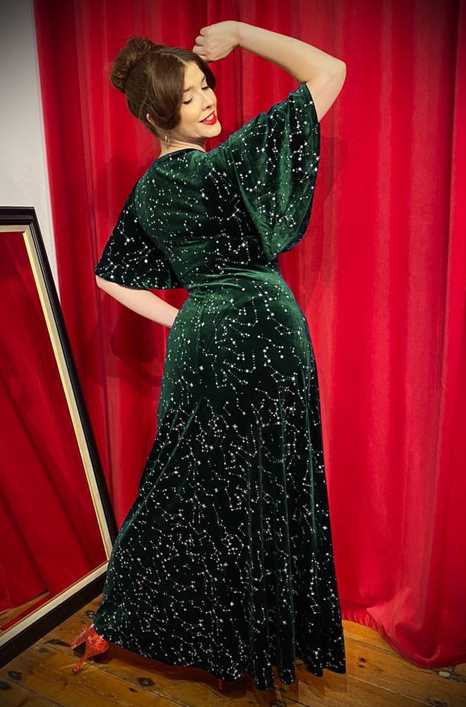 The Stars Maxi Dress is a bewitching 1970s-style maxi dress - crafted in emerald green velvet, with silver stars & keyhole detail.