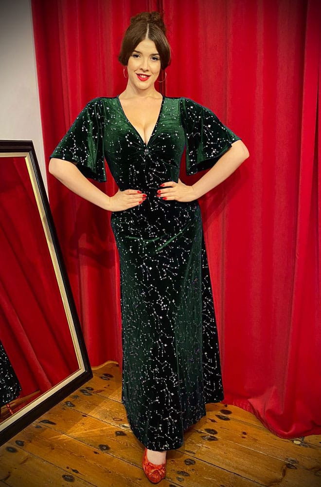 The Stars Maxi Dress is a bewitching 1970s-style maxi dress - crafted in emerald green velvet, with silver stars & keyhole detail.
