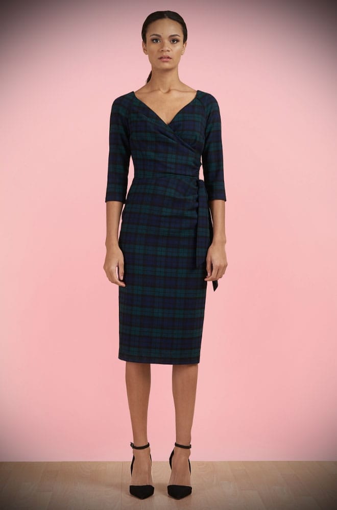The Tartan Hourglass Pencil Dress is timeless but with plenty of sass. This chic dress features a faux wrap bodice, cinched waist, fitted pencil skirt with flattering waist pleats and, a faux side tie.